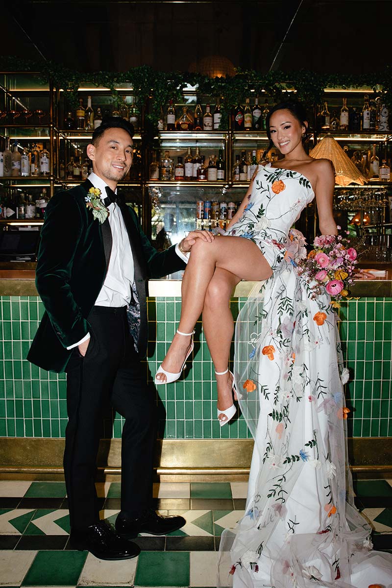 Bride and groom at the Pink Cabana Restaurant bar at Sands Hotel & Spa, Indian Wells — indoor dining in a mid-century modern setting with emerald green tile and brass details